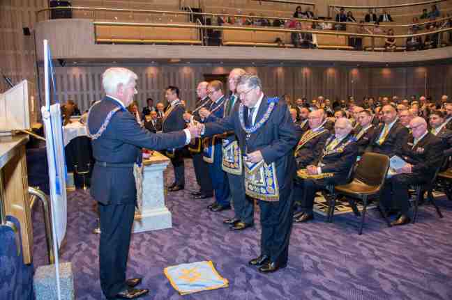 The Grand Master pouring one of the vessels onto the floor.