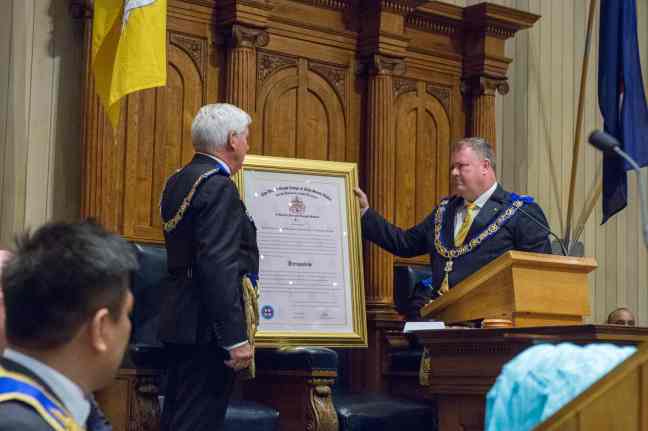 Newly re-installed Worshipful Master, Jamie Melville with the Constitution
